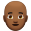 man: medium-dark skin tone, bald on Apple