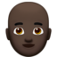man: dark skin tone, bald on Apple
