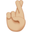 crossed fingers: medium-light skin tone on Apple