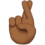 crossed fingers: medium-dark skin tone on Apple