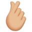 hand with index finger and thumb crossed: medium-light skin tone on Apple