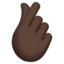 hand with index finger and thumb crossed: dark skin tone on Apple