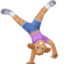 woman cartwheeling: medium-light skin tone on Facebook