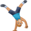 man cartwheeling: medium-light skin tone on Facebook