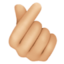 hand with index finger and thumb crossed: medium-light skin tone on Facebook
