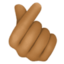 hand with index finger and thumb crossed: medium-dark skin tone on Facebook