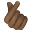 hand with index finger and thumb crossed: dark skin tone on Facebook